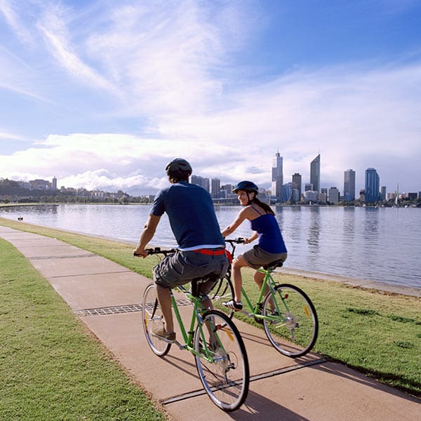 Our Values - Tour organised by Inbound Tour Operator Australia - 39 Degrees South Male and Female on a group bike tour riding alongside a beach. Tour organised by Inbound Tour Operator Australia - 39 Degrees South
